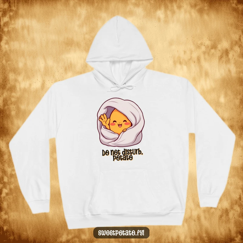 Funny hoodie featuring a sweet potato character waving from inside a plush, cozy blanket, perfect for chilly days.