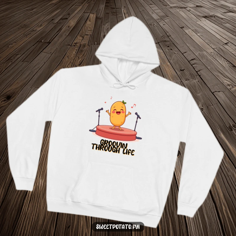 Funny happy sweet potato doing a joyful dance on a miniature stage, a warm and humorous hoodie.
