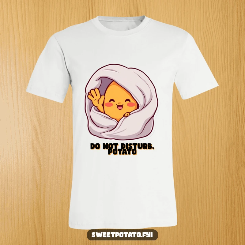 Funny t-shirt depicting a sweet potato character waving from inside a warm, cozy blanket, ideal for comfort lovers.