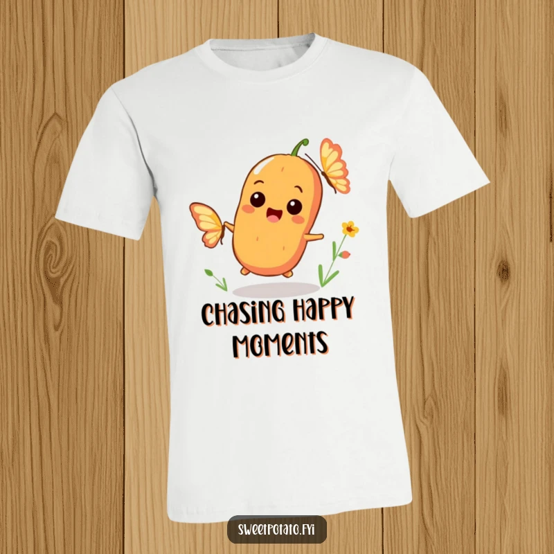 Funny t-shirt of a playful sweet potato character smiling broadly while chasing a fluttering butterfly, representing carefree joy.